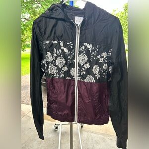 Empyre windbreaker, maroon, white and black with floral design. Size Large.